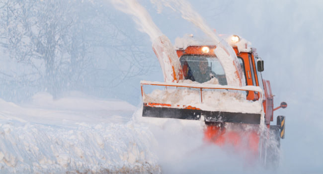 Snow truck cleaning snow from the road and streets Snow truck cleaning snow from the road and streets