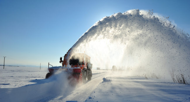 snow vehicle working snow-plowing